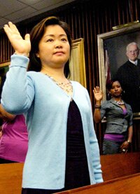 Student taking her oath for citizenship